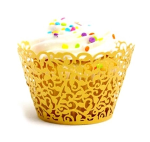 Detailed laser-cut vine patterns on a golden cupcake wrapper showing hollow craftsmanship