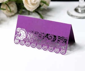 Detailed laser-cut purple lace place card with shimmer finish for wedding table setting
