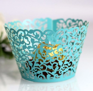 Detailed laser-cut vine patterns on light blue paper cupcake wrapper decoration