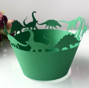 Detailed laser-cut dinosaur cupcake wrappers in dark green paper for party decor