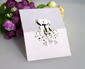 Laser cut wedding place card with kissing couple silhouette and heart on pearlescent paper