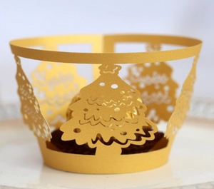 Detailed laser-cut gold Christmas tree cupcake wrapper with Merry Christmas text