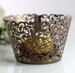 Close-up of laser-cut hollow flower cupcake wrapper in brown pearlescent paper