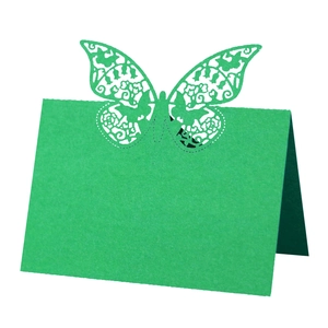 Detail of laser cut green butterfly place card showing intricate patterns and folded design
