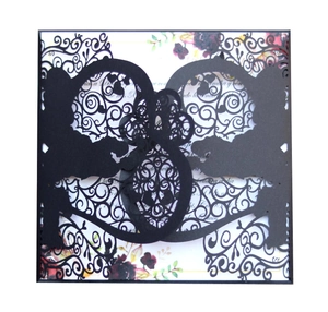 Elegant laser-cut black wedding invitation featuring a romantic couple silhouette and vines