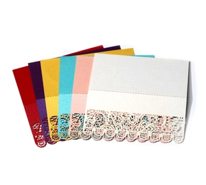 Close-up of laser-cut lace place cards in red, purple, yellow, blue, pink and white