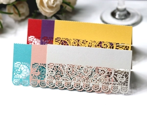 Detailed laser-cut lace floral place cards in multiple colors for wedding table settings