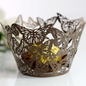 Macro view of laser-cut butterfly cupcake wrappers with pearlescent bronze finish
