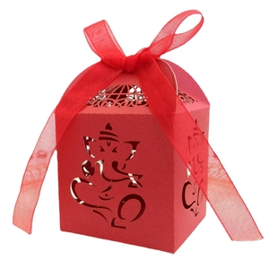 Red laser-cut Ganesha candy box with elegant organza ribbon and hollow design