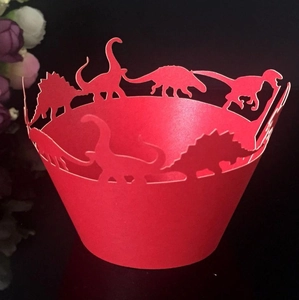 Detailed laser-cut red dinosaur cupcake wrappers featuring stegosaurus and triceratops shapes