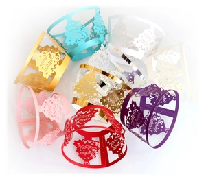 Laser cut Christmas tree cake wrappers and napkin rings in assorted metallic colors