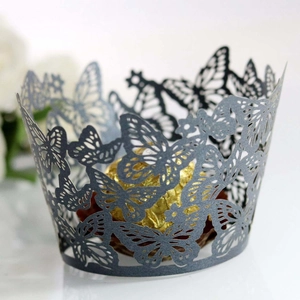 Macro detail of laser-cut butterfly cupcake wrapper with shimmering hollow paper pattern