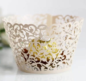 Macro shot of laser-cut floral cupcake wrapper in champagne pearlescent paper