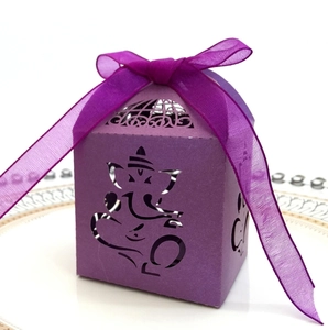 Detail of purple laser-cut candy box featuring Ganesha design and a matching ribbon