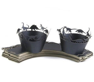 Detail of laser-cut black dinosaur cupcake wrappers with hollow silhouettes for party decor