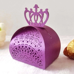 Detail view of purple laser-cut wedding candy box with elegant crown top and floral pattern