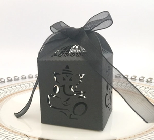 Detail of laser-cut black cardstock gift box with Ganesha motif and organza ribbon
