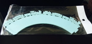 Close-up of light blue laser-cut train pattern cupcake wrappers in bulk packaging