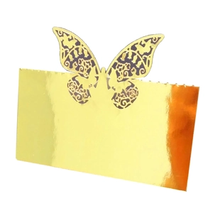 Detailed view of laser-cut butterfly place cards in metallic gold for wedding tables