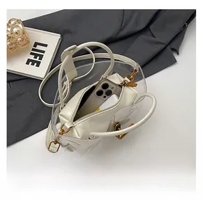 Transparent PVC tote bag with white leather inner pouch showing phone capacity storage