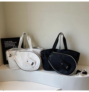 Detail view of large nylon tote bag with unique racket shaped secondary pouch