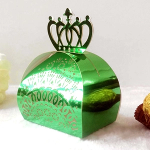 Detail of laser-cut crown candy box in bright green metallic finish for weddings