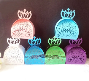 Laser-cut crown wedding favor boxes in various colors with intricate lace patterns