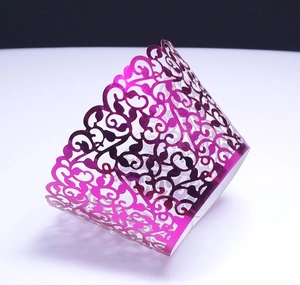 Laser-cut magenta vine pattern cupcake wrapper with pearlescent metallic finish