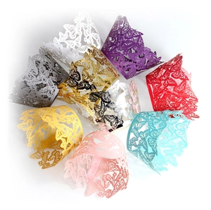 Laser cut butterfly cupcake wrappers in various colors for wedding and party decorations
