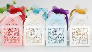 Detailed laser-cut candy box with bird patterns and ribbon for wedding favors