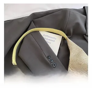 Dettaglio della trama intrecciata beige e del manico in pelle gialla di una borsa tote