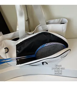 Detailed view of white badminton tote bag with front pocket holding two rackets