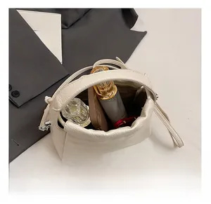 Interior view of white lychee leather mini bag holding phone and perfume essentials