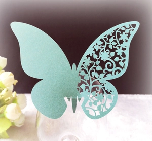 Detail of 3D laser-cut butterfly cup card in mint green pearl paper on glass rim