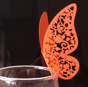 Detailed laser-cut hollow butterfly place card in orange for wedding glass decoration