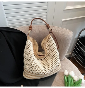 Detail of woven tote bag featuring hollow knit patterns and elegant wooden bead handles