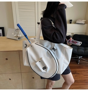 Detail of white sports tote bag showing the specialized badminton racket compartment and pocket