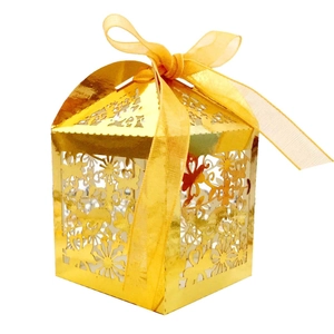 Golden laser-cut wedding candy box with floral patterns and matching ribbon tie