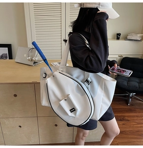 Detail view of large white badminton tote bag with racket compartment and side buckle