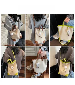 Detailed views of large canvas tote bag with shoulder straps and plush pendant charm