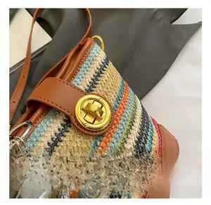 Close-up of woven bucket bag with golden twist lock and colorful bohemian pattern