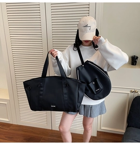 Detail shot of black tote bag and beige baseball cap with refined sporty embroidery