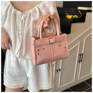 Détail du sac à main en similicuir rose avec design de poche jean et rivets