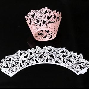 Laser cut butterfly cupcake wrappers in pink and white for elegant party decorations