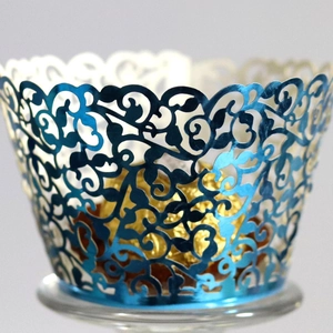 Elegant laser-cut vine cupcake wrappers in navy blue and pearl white for weddings