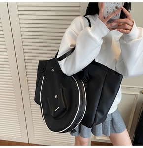 Detail view of black and white badminton tote bag with matching racket cover and pocket