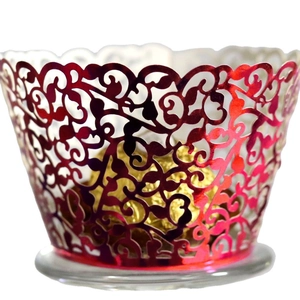 Pink metallic cupcake wrappers with laser-cut vine patterns for elegant baking