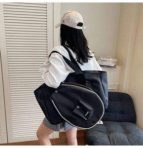 Detail of black sports tote bag and racquet cover with contrast white piping for women