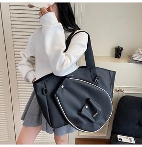 Black large shoulder bag with matching racket-shaped pouch and white piping detail