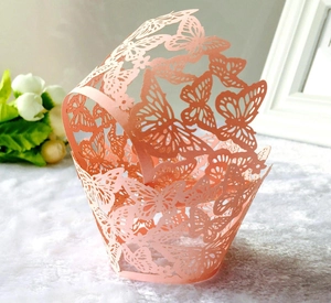 Pink laser-cut butterfly cupcake wrapper in pearlescent paper for party decorations